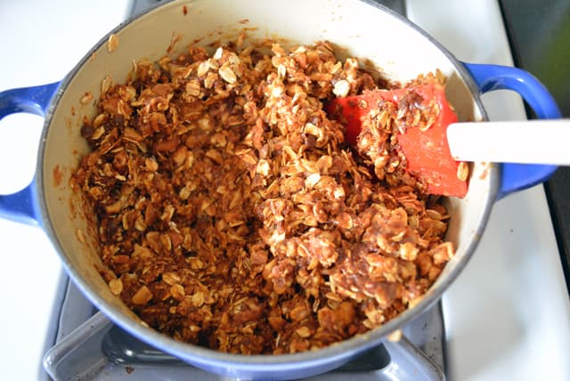 Energy Bar ingredients in a small blue pot with a red rubber spatula.