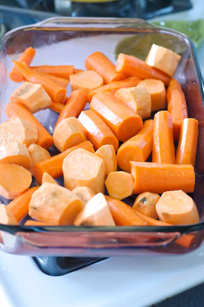 Carrots and sweet potato chucks in a baking dish.