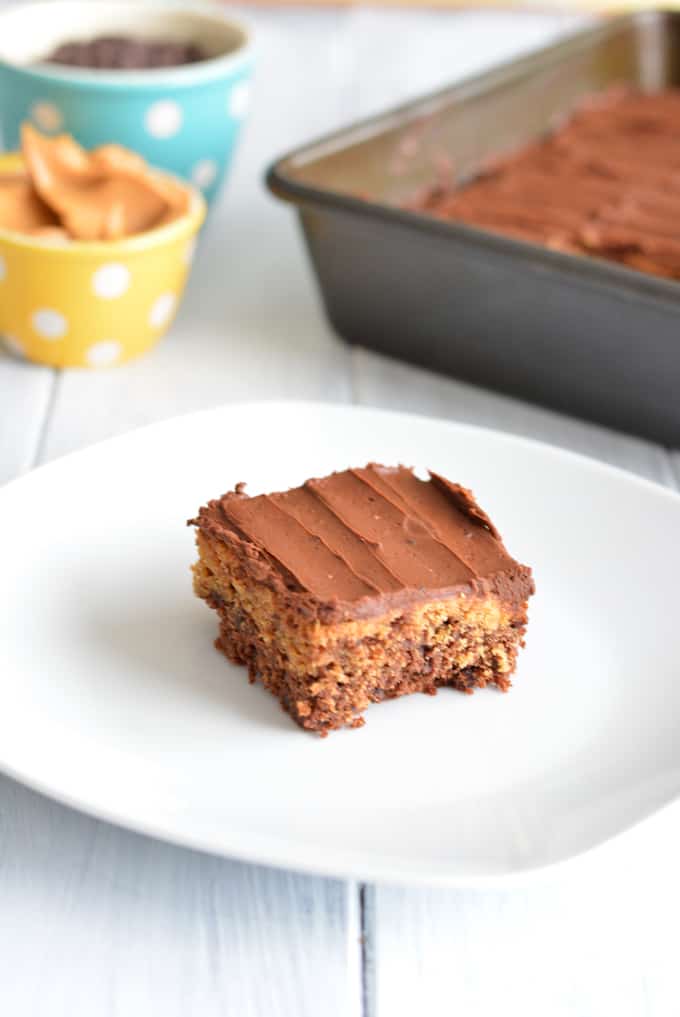 Chocolate Peanut Butter Brownie on a white plate in front of a brownie pan.