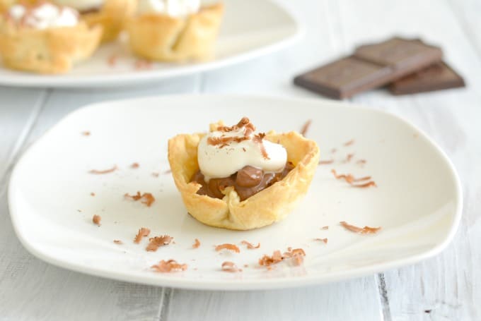 One mini chocolate cream pie on a white plate.