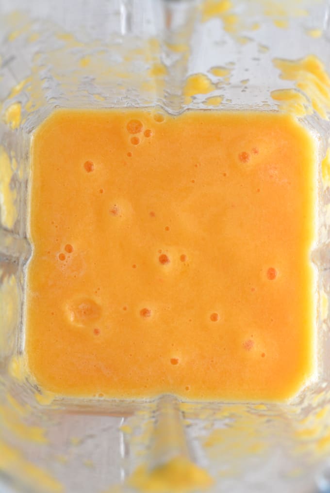 Pureed peaches inside a blender.