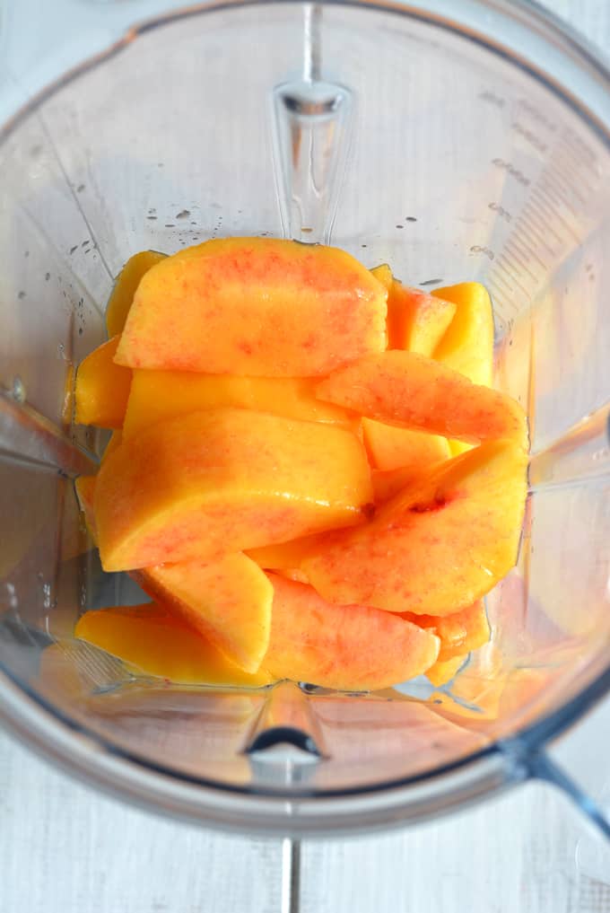 Fresh peaches inside a blender.