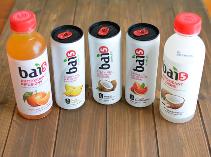 Two bottles and 3 cans of Bai fruit-flavored drinks.