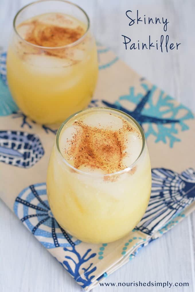 A lower calorie painkiller in a stemless wine glass on a tan and blue napkin.