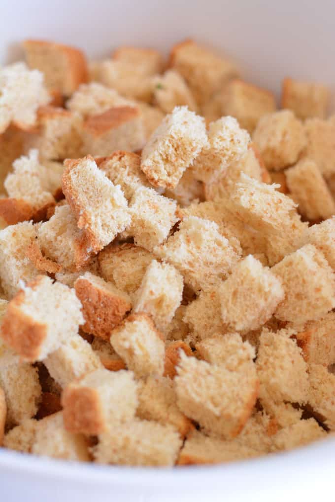 Cubs of whole wheat bread in a white mixing bowl.