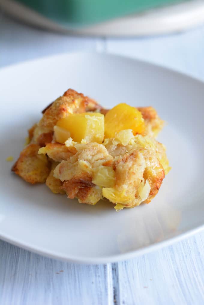 A scoop of pineapple souffle on a white dish.