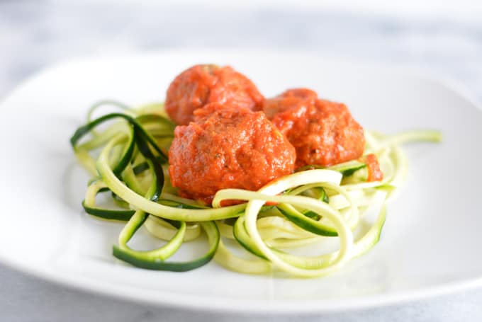 Eggplant Artichoke Meatless Balls on top of zucchini noodles