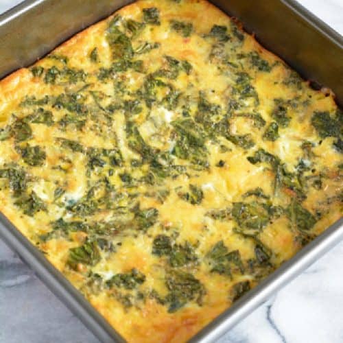 An egg frittata with kale with crust in a baking pan.
