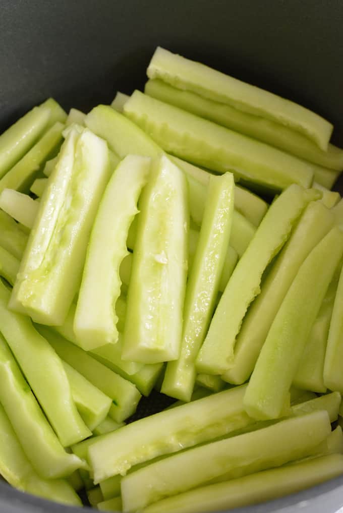 A pile of slice cucumber spears without seeds.
