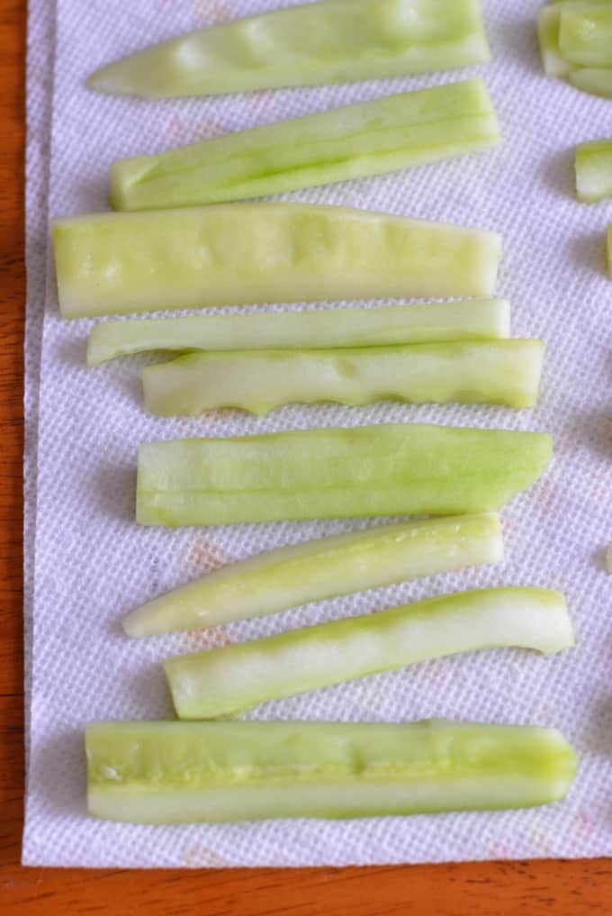 Cucumber slices on a white paper towel.