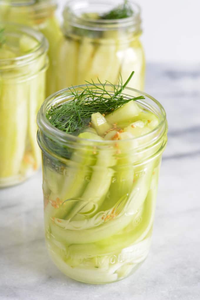 Homemade German Pickles in a mason jar with dill.