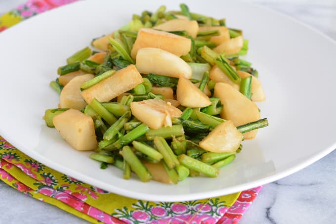 Cooked white turnips on a white plate.