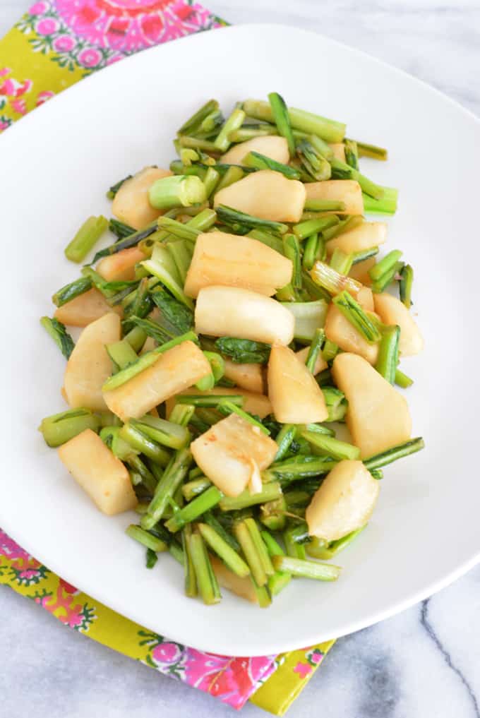 Hakurei Turnips cooked with ginger and soy on a white plate.