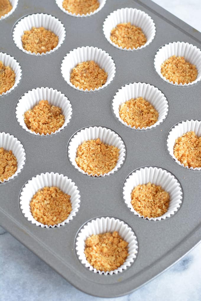 Graham cracker crust in a mini cupcake pan.