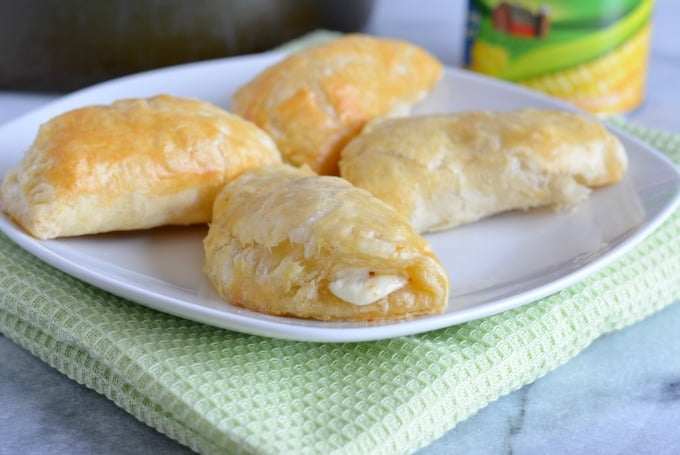 Four Mexican Street Corn Empanadas on a white plate.