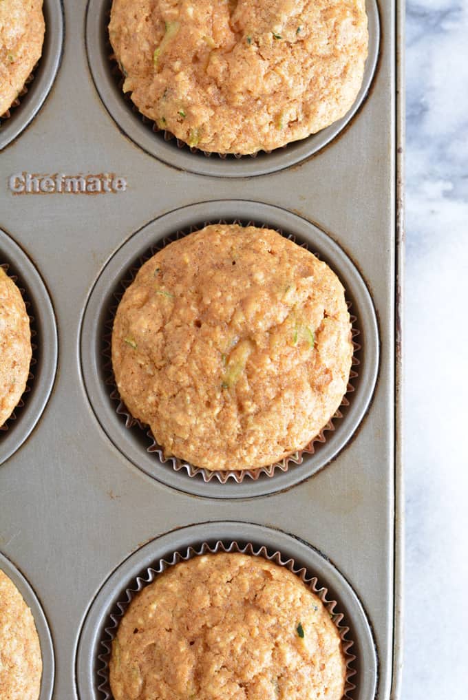 Zucchini muffins baked in a muffin pan.