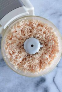 Chopped chicken breast in a food processor.