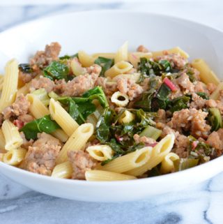 Quick dinners are a necessity. Sausage with garlic Swiss chard over penne is a quick and simple recipe that can be put together in under 30 minutes.