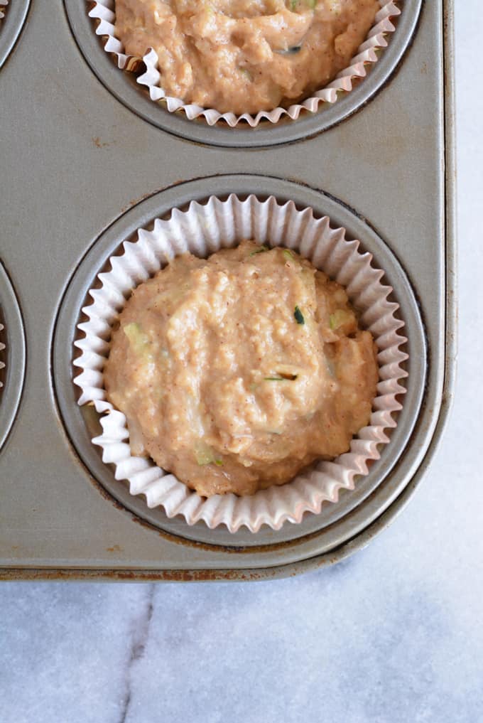 Muffin batter in a muffin pan.