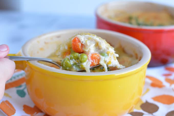 A spoonful of turkey pot pie from a yellow bowl.