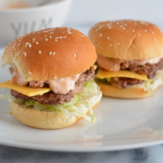 Mini cheese burgers on a plate.