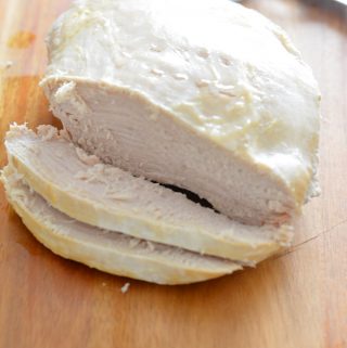 Tender Slow Cooker Turkey Breast on a cutting board.