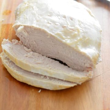 Tender Slow Cooker Turkey Breast on a cutting board.