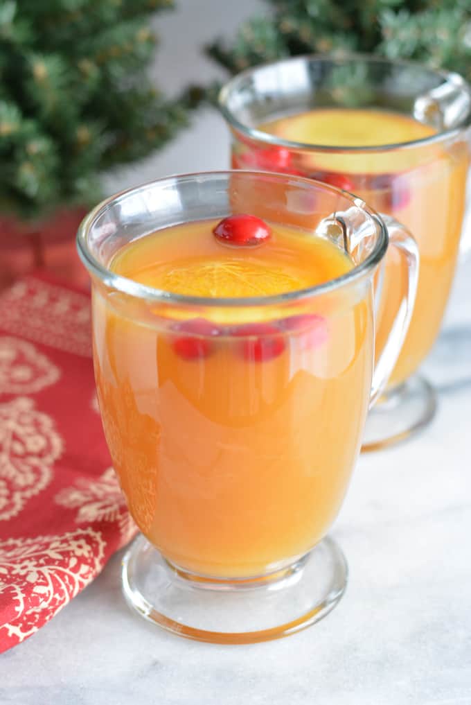 Warm Spiced Apple Cider in a glass coffee mug.