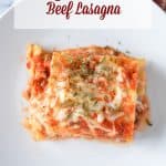 A white plate with a slice of lasagna in the center.
